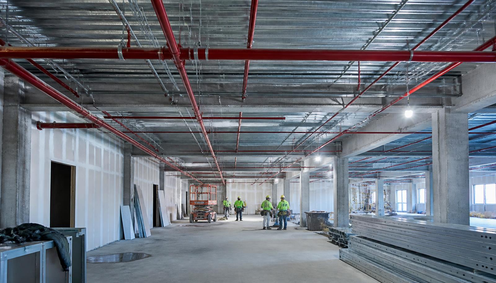 Commercial construction site with installed fire sprinkler piping